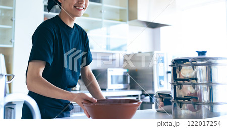 どんぶりを差し出すラーメン屋の店員 122017254