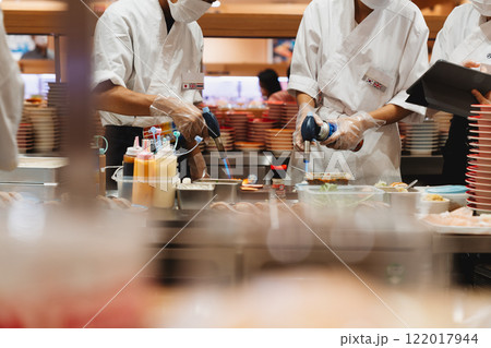 Professional Sushi Chefs Preparing Fresh Dishes in a Restaurant Kitchen Professional Sushi Chefs Preparing Fresh Dishes in a Restaurant Kitchen 122017944