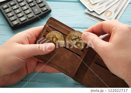 Businessman holding bitcoin. Golden bitcoin coins in man hands. Virtual currency. Crypto currency. New virtual money. Opened wallet. Businessman holding bitcoin. Golden bitcoin coins in man hands. Virtual currency. Crypto currency. New virtual money. Opened wallet. 122022717