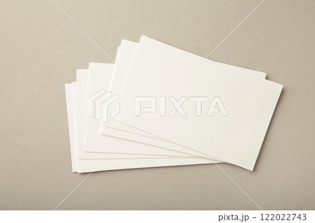 Blank white business cards on grey paper background. Mockup for branding identity. Template for graphic designers portfolios. Blank white business cards on grey paper background. Mockup for branding identity. Template for graphic designers portfolios. 122022743