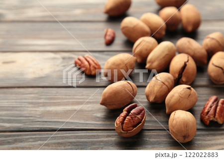 Pecan nuts on a brown wooden table. Top view. Pecan nuts on a brown wooden table. Top view. 122022883