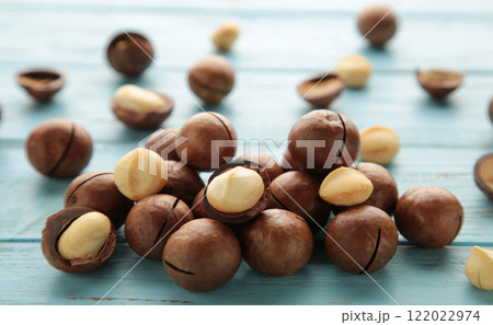 Peeled macadamia nuts. Horizontal composition on blue background. 122022974