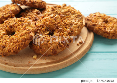 Peanut cookies on cutting board on blue wooden background. Bakery products. 122023038