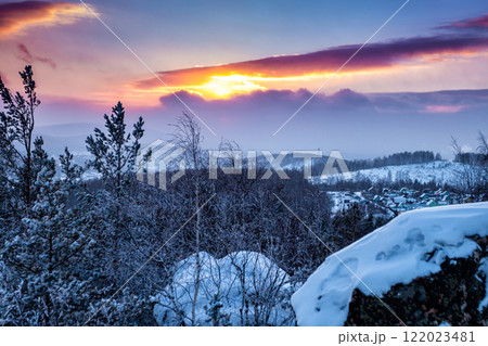 Winter forest and village at sunset 122023481
