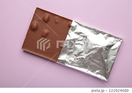 Chocolate wrapped in foil, clipping path on purple background. Chocolate wrapped in foil, clipping path on purple background. 122024080