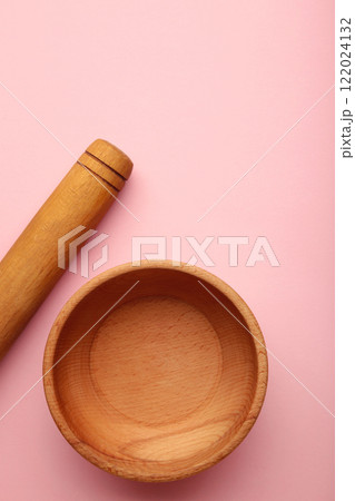 Wooden kitchen utensils on pink background. 122024132