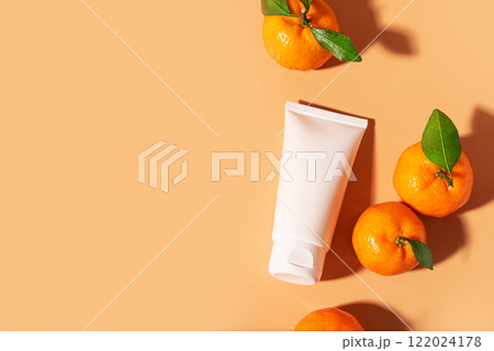 White face cream tube and orange citrus fruit White face cream tube and orange citrus fruit 122024178