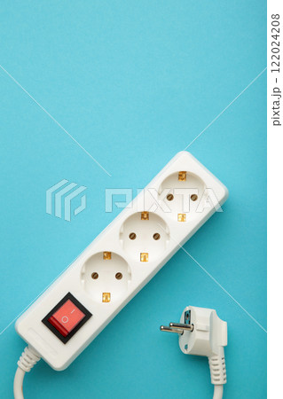 Electric white portable socket on blue background Electric white portable socket on blue background 122024208