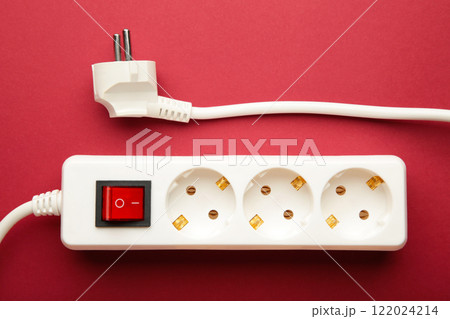 Electric white portable socket on red background 122024214