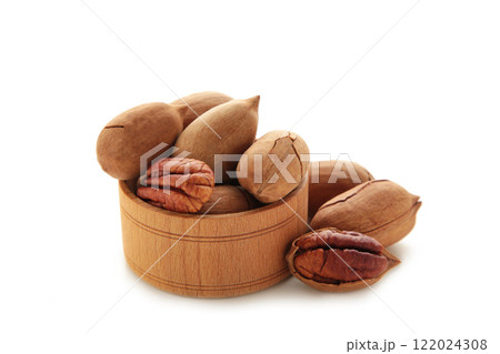 Fresh tasty pecan nuts on wooden bowl isolated on a white background. Fresh tasty pecan nuts on wooden bowl isolated on a white background. 122024308
