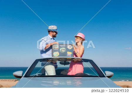 Happy couple in love travel by car by the sea 122024510