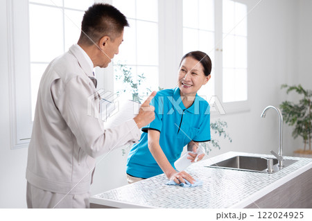 キッチンを掃除するシニアのハウスキーパー 122024925