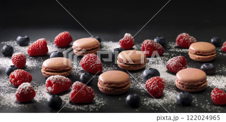 macaroons of different colors on a black background 122024965