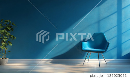 Blue chair sits in front of a wall with a plant. The chair is positioned in a way that it is facing the window, allowing sunlight to shine on it. The room has a clean and minimalist look 122025031