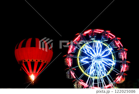 A hot air balloon lit up the night sky.  122025086