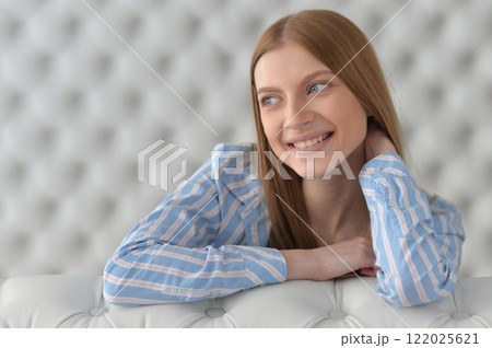 Beauty portrait. Young woman on grey wall background. 122025621