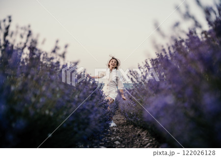 Lavender field happy girl in white dress with a scythe runs through a lilac field of lavender. Aromatherapy travel 122026128