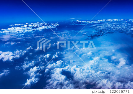 Aerial view from airplane window above green ground. View from the airplane window with beautiful clouds at sunrise. Earth and sky as seen through window of an airplane. High quality photo Aerial view from airplane window above green ground. View from the airplane window with beautiful clouds at sunrise. Earth and sky as seen through window of an airplane. High quality photo 122026771