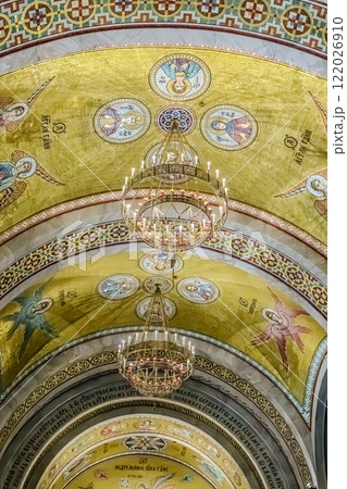 Belgrade, Serbia- 10162024: The Temple Of Saint Sava indoor interior, people pray in an Orthodox church, frescoes on the ceilings and walls of the church. High quality photo 122026910