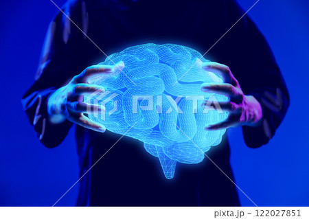 Hands holding glowing digital brain hologram, representing neuroscience research and medical innovation. 122027851