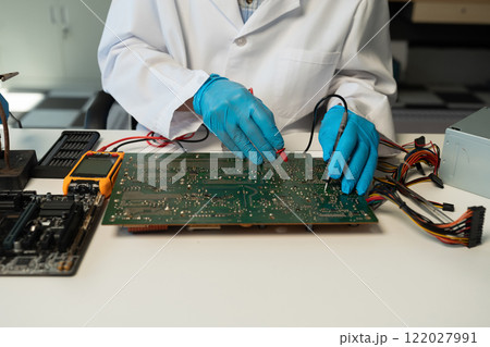 Close up of Technician measuring voltage electronic circuit board, Service after sale fix electric equipment. 122027991