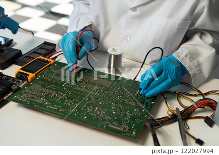 Close up of Technician measuring voltage electronic circuit board, Service after sale fix electric equipment. Close up of Technician measuring voltage electronic circuit board, Service after sale fix electric equipment. 122027994