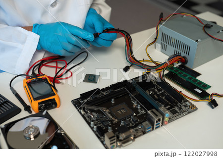 Close up of Technician measuring voltage electronic circuit board, Service after sale fix electric equipment. 122027998
