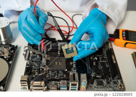 Close up of Technician measuring voltage electronic circuit board, Service after sale fix electric equipment. 122028005