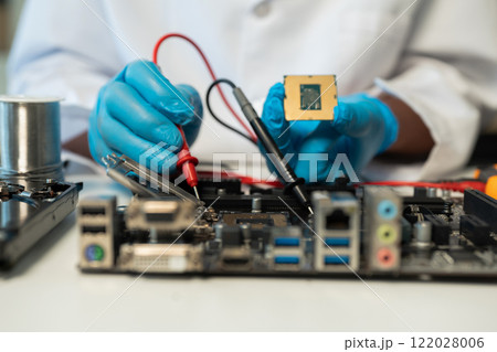 Close up of Technician measuring voltage electronic circuit board, Service after sale fix electric equipment. Close up of Technician measuring voltage electronic circuit board, Service after sale fix electric equipment. 122028006