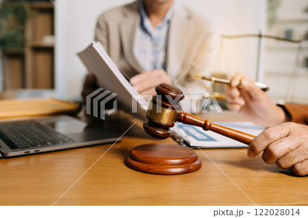Teamwork of business lawyer meeting working hard about legal legislation in courtroom to help their customer Teamwork of business lawyer meeting working hard about legal legislation in courtroom to help their customer 122028014