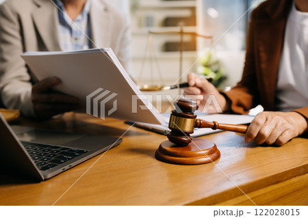 Teamwork of business lawyer meeting working hard about legal legislation in courtroom to help their customer Teamwork of business lawyer meeting working hard about legal legislation in courtroom to help their customer 122028015