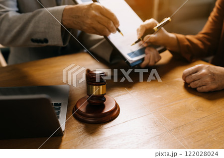 Teamwork of business lawyer meeting working hard about legal legislation in courtroom to help their customer. 122028024