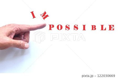 human hand poking impossible to possible words on white paper background human hand poking impossible to possible words on white paper background 122030669