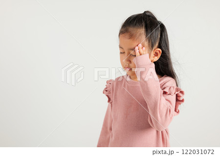 Portrait of Asian young kid girl sad tired strain face holding hold head by hands, stress kindergarten child person unhappy closed eyes problem headache, studio shot isolated on white background 122031072