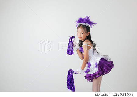 Portrait of a cheerful cheerleader girl in a purple and white outfit, holding purple pom-poms. Smiling brightly in a studio shot against white background. Energetic and festive vibes. cheerleader kid Portrait of a cheerful cheerleader girl in a purple and white outfit, holding purple pom-poms. Smiling brightly in a studio shot against white background. Energetic and festive vibes. cheerleader kid 122031073
