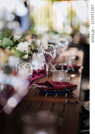 Elegant wine glass and water glass on a rustic table, perfect for fine dining and event settings 122031367