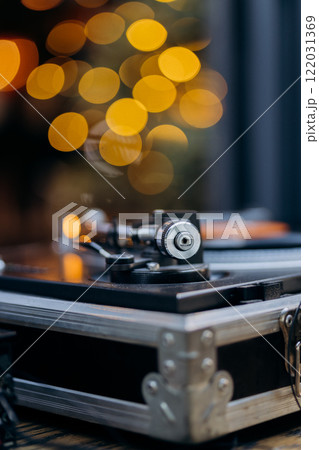 Close-up of a turntable needle on a spinning vinyl record, capturing the essence of retro sound Close-up of a turntable needle on a spinning vinyl record, capturing the essence of retro sound 122031369