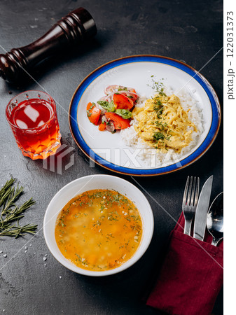 Delicious homemade lunch with soup, rice, curry, fresh salad, and a refreshing red drink Delicious homemade lunch with soup, rice, curry, fresh salad, and a refreshing red drink 122031373