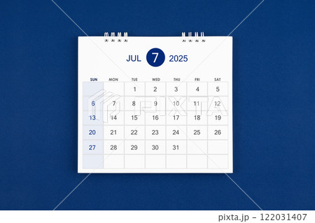 July 2025 Monthly desk calendar on navy blue leather background. 122031407