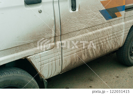 dirty white car on the city street. Mud-splattered truck in the city center dirty white car on the city street. Mud-splattered truck in the city center 122031415