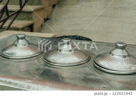 metal containers for ice cream sales. iron Turkish ice cream bowls at the amusement park metal containers for ice cream sales. iron Turkish ice cream bowls at the amusement park 122031442