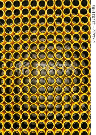 texture of yellow plastic hose. pieces of rubber hose stuck together 122031498