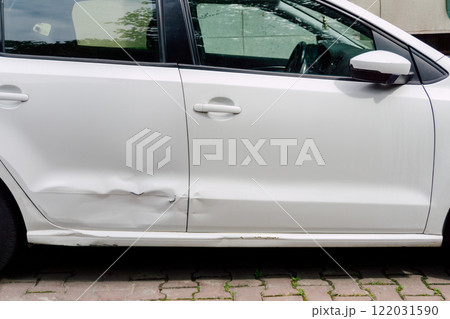 dented rear door of white car. damage to metal of car due to parking dented rear door of white car. damage to metal of car due to parking 122031590