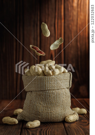 peanuts falling in sack on table 122032683