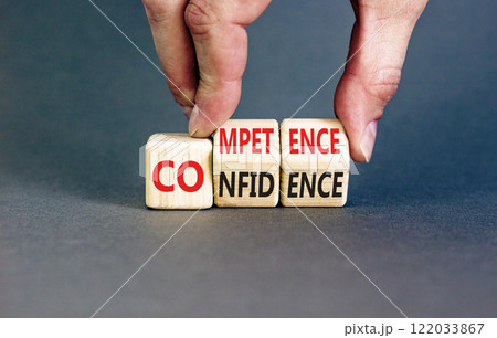 Competence and confidence symbol. Concept word Competence Confidence on wooden cubes. Businessman hand. Beautiful grey table grey background. Business competence confidence concept. Copy space. 122033867