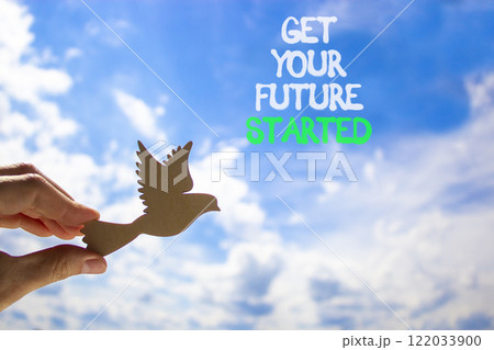Get your future started symbol. Concept words Get your future started. Beautiful blue sky and clouds background. Businessman hand with wooden bird. Business get your future started concept. Copy space 122033900