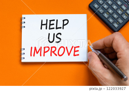 Help us improve symbol. Concept words Help us improve on beautiful white note. Beautiful orange background. Black pen. Businessman hand. Business motivational help us improve concept. Copy space. 122033927