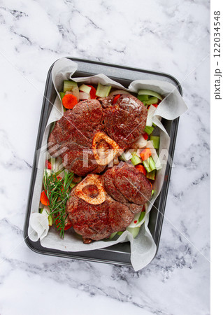 fried meat on the bone, raw, chopped vegetables, ingredients in the oven, for cooking ossobuco, top view, no people, fried meat on the bone, raw, chopped vegetables, ingredients in the oven, for cooking ossobuco, top view, no people, 122034548
