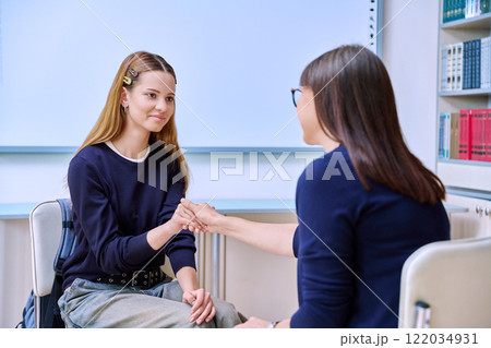 Teenage student girl talking with female social worker, school counselor, teacher 122034931