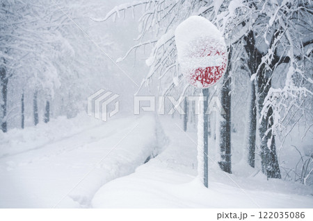 Snow covered road sign in winter forest 122035086
